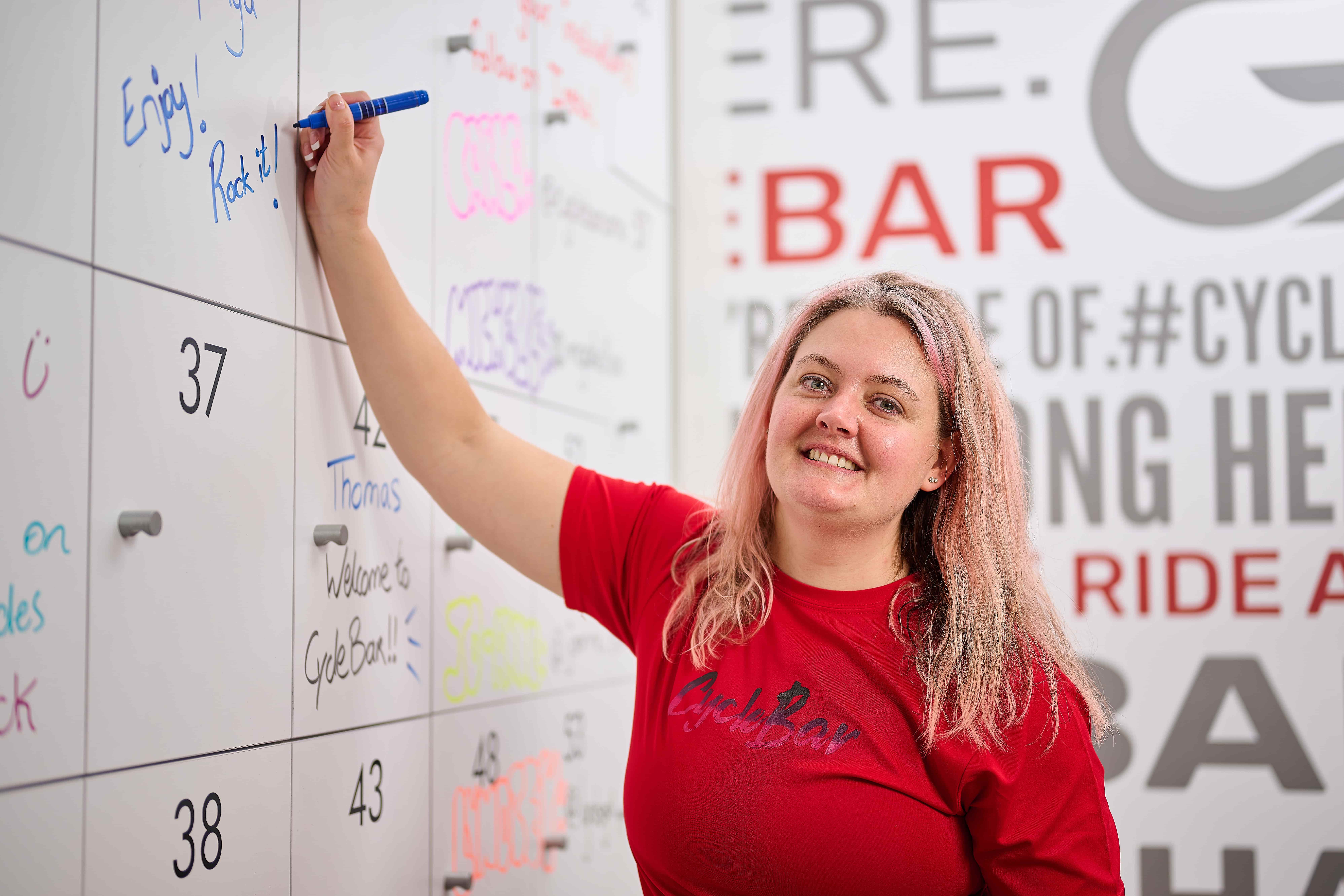 woman marking achievements after a cycle bar class
